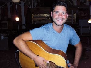 Singer/songwriter Tim Styles was “home” on the North Shore this summer, appearing at several venues and on stage at the Fisherman’s Picnic. He is pictured here at his concert at Betsy Bowen’s What’s Upstairs. Left: In addition to an entertaining and diverse mix of music on his Just Bein’ Alive album, there are some fun photos of Tim Styles in Nashville.