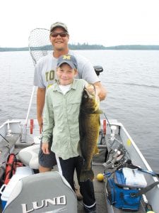 Ben Higgins shows off the 30 ½-inch walleye that he caught fishing with guide (and Tails from the Trail columnist) Cory Christianson on Saganaga Lake on August 6, 2011.