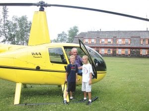 Helicopter pilot Len Busch with grandsons of Naniboujou Lodge owners Tim and Nancy Ramey. Andrew and Luke Rudolph got to take a unique look at the North Shore when Len gave them a ride in the helicopter.