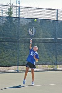 Cook County seventh-grader Hannah Toftey focuses on the ball as she serves against Marshall’s No. 1 doubles team on August 25.