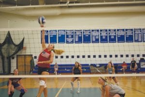 Volleyball practice has been fast paced. Here, with her teammates to back her up, Ali Iverson goes up high to spike the ball. The CCHS girls' volleyball team is coming off a 20-4 record last year and even though they lost some key players through graduation, look to be a contender for the conference crown once again.