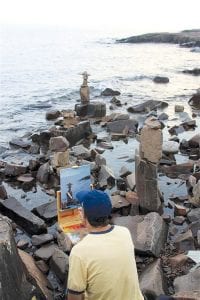 Forty-four artists traveled from near and far for the Grand Marais Art Colony Plein Air Competition August 26 to September 2. On the Point, Matt Kania puts finishing touches on a painting of the omnipresent rock cairns.