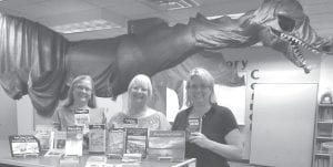 Sawtooth Elementary’s Media Center Director Shelby Anderson, Linda Ottis of the Emera Chapter and Principal Gwen Carman with the nature books donated by the Eastern Star.