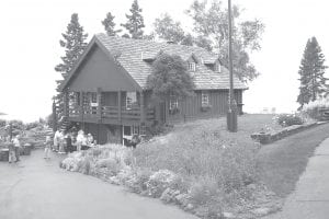 The Schroeder Area Historical Society’s seventh annual Lundie tour was a rousing success. Named after Minnesota architect Edwin Lundie, it featured seven homes, two designed by Lundie. (Above) A picnic overlooking Lake Superior was held at the end of the tour at one of the Lundie homes. (Above right) The day was enjoyed – and captured in film -- by people of all ages. (Right) A wall of windows overlooking Lake Superior in a cabin Lundie built for himself and his family.