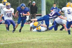 Viking quarterback Kale Boomer ran hard against the Esko Eskomos last Friday, September 2. Here he follows the lead block of Peter Warren as he scampers for about 5 yards. Although the Vikings played hard, they lost 42-14 to their Division 3A rivals. Esko suited up almost three times more players than the Vikings for this game.