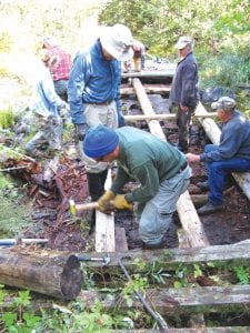 The construction crew used a series of rollers, levers, pickaroons, a timber jack, cant hook and manual lifting to remove the old bridge and reconstruct the 40-footlong bridge.