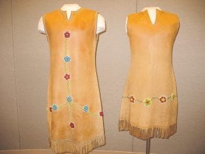 The beautiful craftwork created by Grand Portage community elders at the National Monument from 1968 to 2002 is now on display at the Grand Portage National Monument Heritage Center. Top: These simple and elegant beaded leather dresses were created by Cecelia Hendrickson and Mary Dahl. Upper left: Dora Kasames created this intricate hairpiece with a beaded rose. Upper right: Using beads and quills, Sharon Vogel made these exquisite earrings.