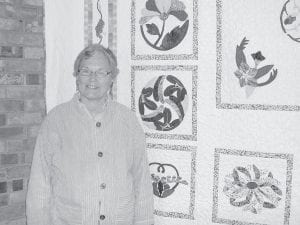 Above: At the Wednesday, September 28 sewing party, at Zoar Lutheran Church, a beautiful quilt created by Polly Erickson (pictured with the exquisitely hand-appliquéd quilt) was unveiled. Erickson donated the quilt to Zoar Lutheran Church and it will be raffled, with the drawing held at the church's lutefisk dinner in November. Left: Dory Spence (front), Orlene Fisher and Polly Erickson sewing away at the gathering on Wednesday, September 28.