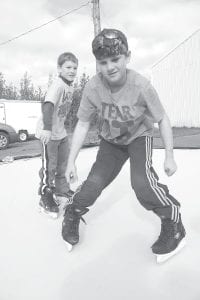 Tanner and Trevor Berglund gave the county’s 16’x16’ synthetic ice sample a try a few days after it arrived. Opinions on the artificial ice have been mixed. The Cook County Amateur Hockey Association does want it, however, but would like to wait to have a concrete pad in place before the county invests in a full-sized rink of the synthetic material.