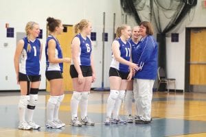 Above: On October 4, before the match up with Barnum, the senior volleyball players were recognized in front of the home crowd. Here Coach Pam Taylor congratulates Michaela Buchheit, Ashley Deshampe, Sarah Fagerman and Cecelia Olsen for all of their contributions to the team.