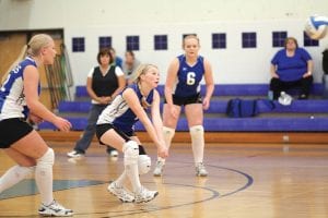 Left: Micheala Buchheit gets ready to bump the ball while Sarah Fagermann and Cecelia Olsen looks on.