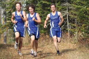 Above: The Viking boys' cross country team shows its moxie by running in a pack at the recent conference meet held at Pincushion. Here, from left to right are Shawn MacDonell, Will Seaton and Alex Ditmanson.