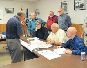 Superior National at Lutsen Golf Course Manager Bob Fenwick explains the proposed redesign of the golf course to the EDA board (L-R, seated) Don Davison, Mark Sandbo, Bob Spry. (L-R, standing) Jim Hall, Golf Course Committee Member Marland Hansen, Bruce Martinson.