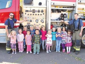 During Fire Prevention Week, October 9-15, local fire departments visited local schools. The visits are greatly enjoyed by the enthusiast kids who get to check out fire trucks and take a turn spraying the fire hose. They also hear a fire safety message. Kids at North Shore Preschool were very excited about the visit from the Grand Marais Fire Department. (L-R) Fire Chief Ben Silence, Grete, Sophia, Carter, Brianna, Reuben, Brenton (front), Jake, Liv, Aria, Kaj, Rachel, Frances, Molly, Firefighter Gideon Silence.