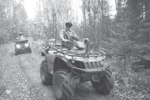 Above: Jessica Bockovich of Silver Bay gives a wave from the trail. Left: Enjoying the day were Fred and Susie of Castle Danger, MN and Tait Lake. Fred remembered that it was hunting season and donned orange for the ride.