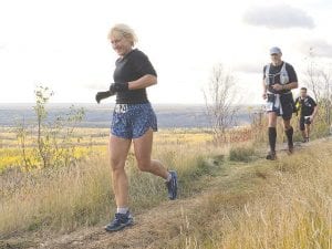 It must be the early stages of the Wild Duluth 50K (31 miles) trail race because Deb Bennett and Mark Falk look relaxed and are still smiling as they head toward the finish line. While Falk ended up just ahead of Bennett, Deb won first place for her age group.