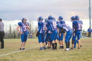 Above: Peter Warren (33) talks to his teammates during a break in the action. Warren, a running back, scored a 50-yard touchdown run against Deer River and had an all-around great game against the Warriors. Right: Mike Sjogren showed again his ability to get up for big games as he led the Vikings in a furious comeback against Deer River, catching a pass for a touchdown and running a kick back 89 yards for a TD. Far right: Dylan Quaife (10) scored the Vikings' first touchdown of the game against Deer River on a 9-yard run.