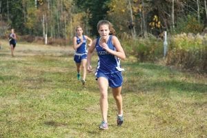 Left: Audrey Summers had her best race of the season at Sections when she finished in 22nd place with a new personal best of 16:50 for the 4k race. Above: Ben Seaton (with a slight lead over teammate Joey Chmelik) placed 29th at Sections with a new personal best of 18:08 for 5k (3.1 miles). Chmelik finished 53rd out of the 180 runners with a fine time of 19:09. Right: Mara MacDonell placed 84th in the Girls' varsity race with a new PR of 20:24.