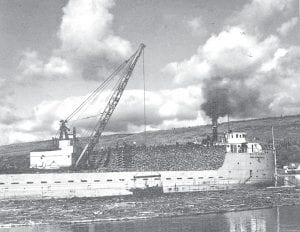 Eleanor Waha shared this interesting photo of a ship being loaded with pulpwood in the Grand Marais harbor sometime in the early 1940s. If you look very closely, in the background you can see the former Seawall Motel.