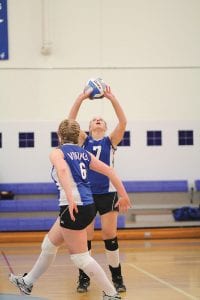 Sarah Fagerman (6) gets ready in case Abbey Sutton (7) sets the ball to her in the girls' recent match against Cherry.