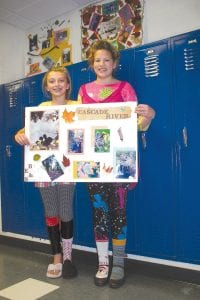 Cook County Middle School students enjoyed a beautiful fall day outdoors on September 23 and recorded the adventure for a Photo Essay Contest. Taking first place in the contest were Sarah Toftey (left) and Emily Jacobsen, who paused during Homecoming “Crazy Day” to pose with their winning photos and display.