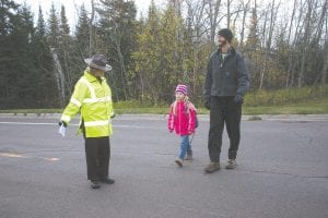 Trooper Leah Carpenter stands guard as families catch the “school bus.” There were 15 adults and 35 kids “on the bus.” Organizer Kristen DeArruda Wharton said a similar event will be held in the spring.