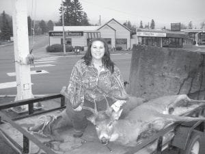 Teri Smith of Grand Portage leads the Big Buck Contest in the largest dressed weight category with her 228-pound buck. The huge buck has beautiful antlers.