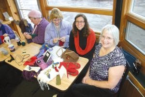 Cook County has a wonderful array of fiber artists. They meet at a number of locations throughout the county to share their favorite pastime. This group meets at Java Moose in Grand Marais on Tuesdays. Some of the group members are (L-R) Fran Kosciek, Nancy Kemp, Nina Simonowicz, and Linda Blaine-Ottis with just a small sampling of the beautiful items that will be on display—and for sale—at the Northwoods Fiber Guild Holiday Open House on Saturday, Dec. 3.