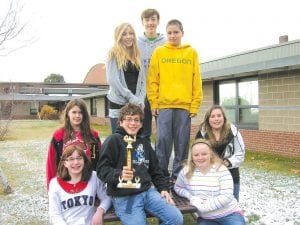 Photo courtesy of ISD 166 Champs! The Cook County Middle School Knowledge Bowl team won all of its meets and claimed first place in the regional tournament on November 22. The champs are (L-R, front) Sara Carman, Will Seaton (with trophy), Madison Roy. (L-R, middle) Julia Larsen, Erica Weisberg. (L-R, back) Morgan Weyrens-Welch, Sean MacDonell, Pete Summers.