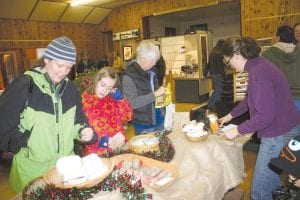 The Hovland Arts Festival Artisan’s Christmas Sale on Nov. 26 had many beautiful gifts. These shoppers were interested in the natural soaps made by Hartley Acero.