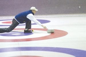 Right: Long time curler Bill Parish shows his form as he sends a rock down the ice.