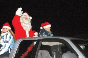 Ho-ho-ho! There were Santas aplenty at the Grand Marais Chamber of Commerce Christmas Parade on Friday, November 25. This Santa and his helpers waved to the crowd and shared candy with parade-goers from the Chamber’s float. Another Santa arrived by dog sled to help light the big Christmas tree in Harbor Park. See more holiday fun on page A3.