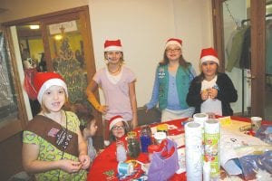 There were a lot of elves working at Santa’s Workshop on Saturday, December 3. The day started with a pancake breakfast and there was holiday shopping with help from the elves all day. These young ladies helped out by providing child care and arts and crafts.