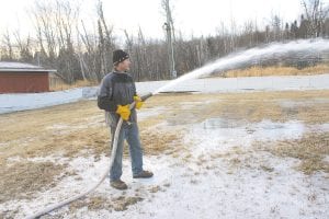 Let it freeze! The Birch Grove Community Center is almost ready for skating. On Tuesday, December 6, Charles Lamb and Greg Vetter used the Tofte Fire Department's 5,000-gallon tanker to flood the Birch Grove skating rink. This is the last year for the current rink—next spring the ground will be broken for a new rink and warming house.