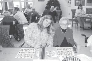 Margo Florell with her grand daughter Laurie Bradley at Margot’s 105-birthday party held at the North Shore Care Center. One of the activities Margo still participates in is playing Bingo, as seen here.