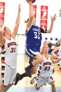 Above: Using her great leg speed, Molly Zafft split two Nashwauk Keewatin defenders on her way to the basket for two points in a game played at home on Friday, December 2. Left: Senior guard Ashley Deschampe wheels around the Nashwauk Keewatin defenders to score two points. Deschampe is averaging about 23 points a game over the team’s first two games and is on pace to become Cook County’s all-time scoring leader this year.