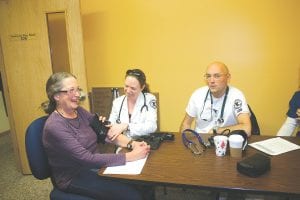 Left: Open house attendees were treated to free blood pressure checks from nursing students. Above: Executive Director Paula Sundet Wolf was happy to write, “We made it!” on the board tracking Higher Ed’s endowment fundraising goal.