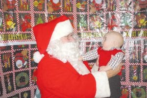 A fun family tradition continued on Sunday, Dec. 11 at American Legion Post 413. The Legion Auxiliary hosted a Christmas Carnival complete with a visit from Santa Claus. Baby J.T. Yeary was not sure what to think about St. Nick. J.T. didn’t cry, but he also didn’t look too happy.