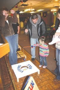 While waiting for Santa to arrive kids enjoyed carnival games like this “ice fishing” game. Little Madeline gets a cheer from her dad and Auxiliary Member Billi Carlson when she successfully “hooks” a fish.