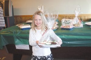 The Cake Walk is always a popular activity, with many beautiful holiday cakes. Kamryn Johnson was delighted with her pretty Christmas cake.