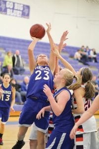 Theresa Morrin goes up strong for a lay-up while Kaitlynn Linnell gets ready to rebound. Morrin, a junior, has been a bright spot for the Vikings as she has stepped up into a starting spot this season. Linnell, a sophomore, gives the team some height at center and is getting better with each game.