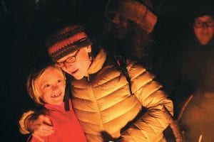 Above left: Gina Todd and a young friend laugh about the whimsical light show puppet characters.