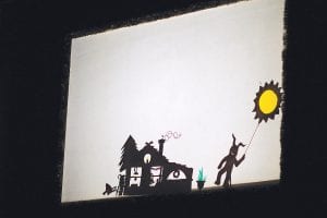 Above right: One of the puppets chased away the darkness, in the form of a very scary monster with the sun.