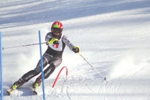 Showing strong slalom technique as he slashed around a gate, Dexter Yoki (above) placed 7th at the Virginia Invitational at Giants Ridge to help the Vikings boys' varsity place first overall in the slalom event. Megan Lehto, above left, placed 14th and Morgan Weyrens-Welch (left) placed 15th in the girls' varsity race at Virginia to help the Vikings win first place. It was a terrific meet for the Vikings as the junior varsity also placed first in the slalom races.