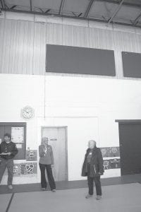 Staff photo/Brian Larsen Deb Waage (left) talks to school board member Mary Sanders about the noise reduction panels (above them) the school recently received and installed after they were awarded a grant from the Lloyd K. Johnson Foundation. The panels were installed in the elementary school gymnasium, which, at times, can get quite loud.