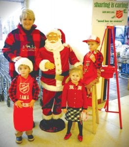 The Salvation Army Red Kettle campaign was very successful—and people had a lot of fun taking time to ring the bell, like Cathi Williams and her grandchildren. (L-R) Oscar Mielke, Cathi Williams, “Santa,” Grete Youngdahl and Reuben Youngdahl, with bell. The amount collected was slightly down, said Donna Gestel, one of the Red Kettle Campaign Committee members. Gestel said the total to date was $8,463.17. Last year the total was over $9,000, but Gestel said sometimes additional money comes in the days following the campaign. “We are fairly close to last year, which is good,” said Gestel.