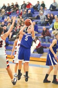 Left: Ashley Deschampe is now the all-time highest point leader for the Cook County girls' basketball team. She passed 2002 graduate Malinda Berglund who scored 1,318 points for CCHS over her illustrious career. Ashley, a senior guard, is averaging about 22 points per game this season. Above: Bekah Laky goes around two defenders as she wheels to the basket for a lay-up. At 5’7”, Laky is truly a “small forward”, but because she knows how to position herself around the basket, she’s always good for 6-10 rebounds per game and always plays tough defense against her (generally) taller opponents.