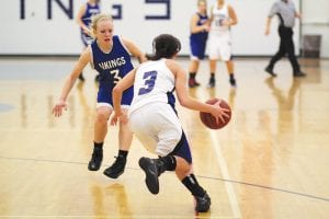 Upper left: Jessica Berg-Collman (3) clamps down on defense. Above left: the Vikings' eighth-grade center Lily Gruber-Schulz gets ready to take the ball to the hole for two points. Above right: Breana Peterson doesn’t shoot often but when she does she often scores. The Vikings have won their last two games and are back on track after a rough December.