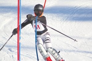 Joe Borud does what all good slalom racers do; he bends the gates as he goes around them.