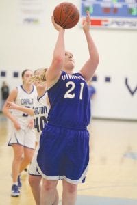 Left: Bekah Laky scored 2 of her 19 points against Carlton on this basket. Above left: When she’s not stealing the ball or slashing to the basket for a hard earned lay-up, Theresa Morrin (23) is passing the ball to a teammate. Above right: Playing at her usual 100 mile an hour pace, Leah Utities (4) gets ready to pivot around her defender and make a nice pass.